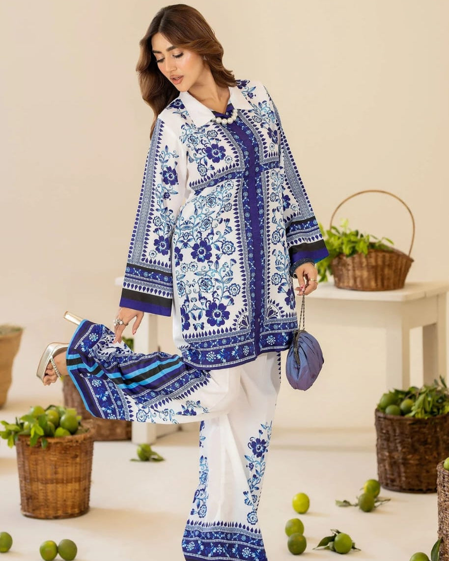 Woman wearing a blue and white patterned outfit with high heels in a decorated room.