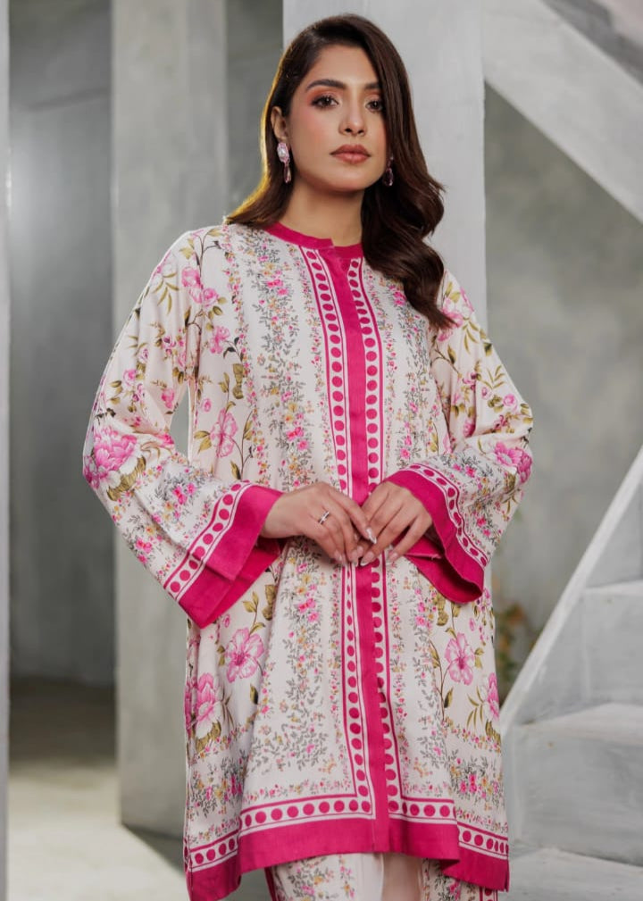 Woman wearing a floral and pink traditional outfit in an indoor setting