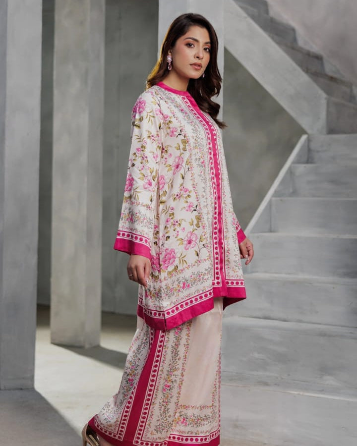 Woman in a traditional outfit standing in a modern architectural setting