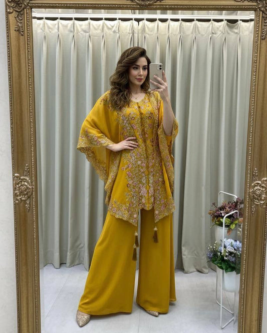Woman taking a mirror selfie wearing a yellow outfit with a floral pattern.