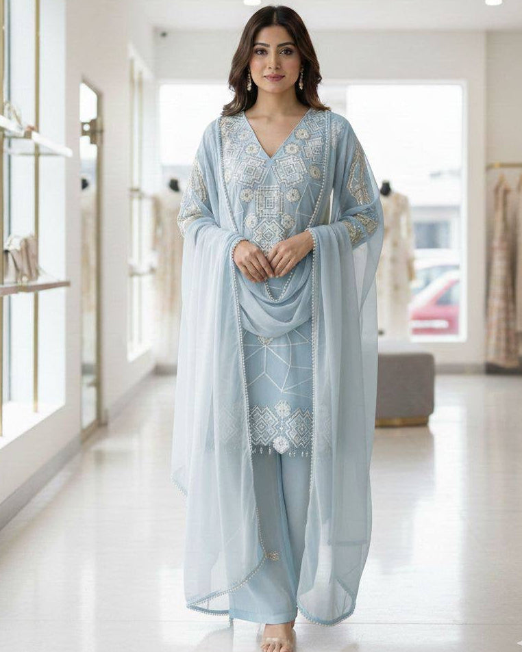 Woman wearing a light blue traditional outfit in a store setting