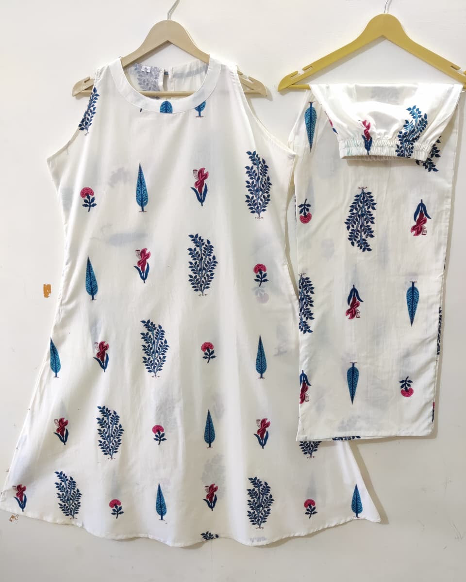 White sleeveless top with floral pattern on a hanger against a white background