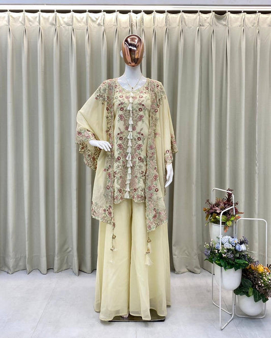 Mannequin wearing a light yellow outfit with floral details against a neutral curtain background.