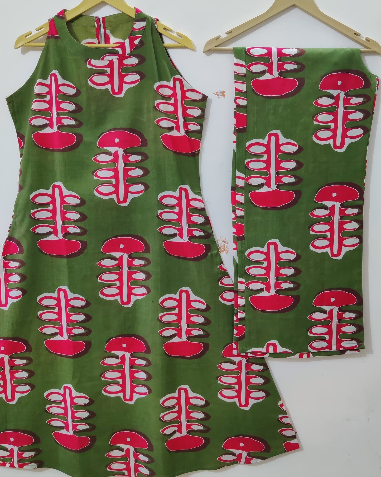 Green dress with red and white pattern on a white background