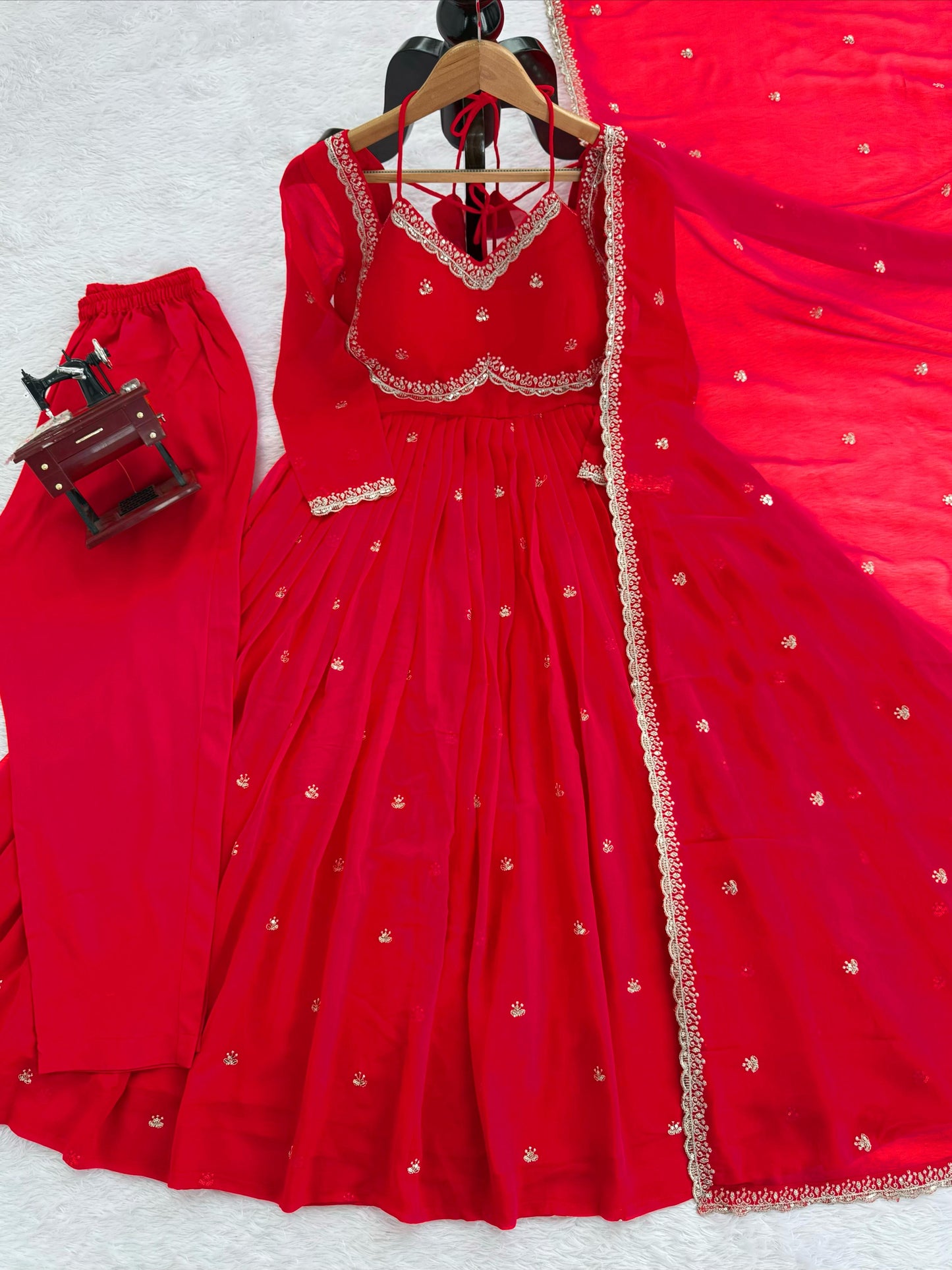 Red traditional outfit with gold embroidery on a white background