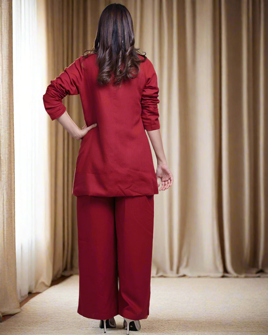 Person wearing a red outfit standing in a room with white walls and furniture.