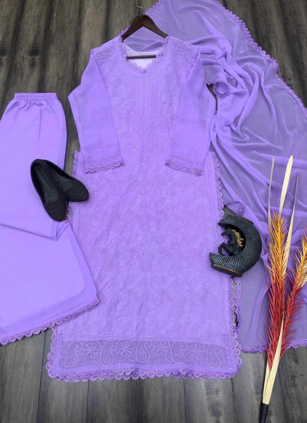 Purple outfit with a matching dupatta on a wooden surface